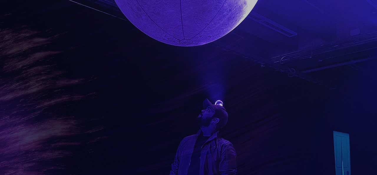 ux designer looking to a moon during an art event in Montreal, Quebec, Canada